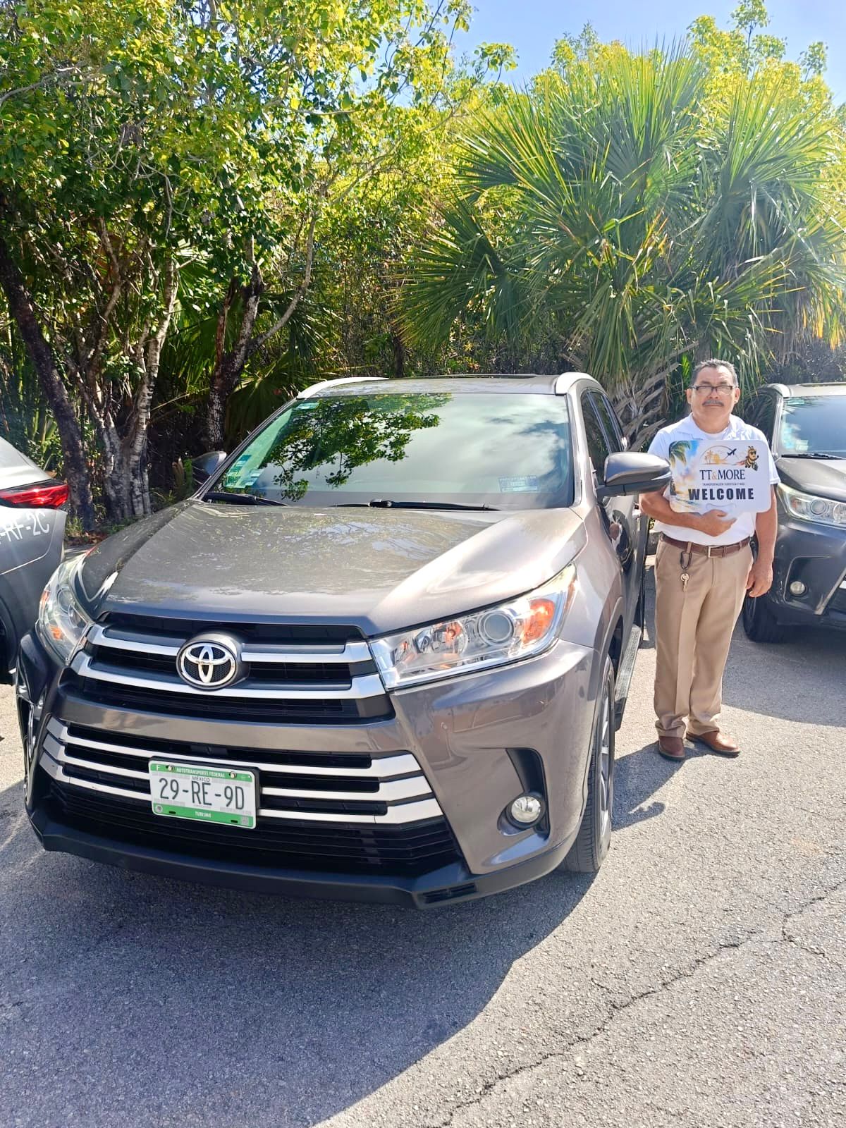 TT & More driver beside a Toyota SUV in Cancun