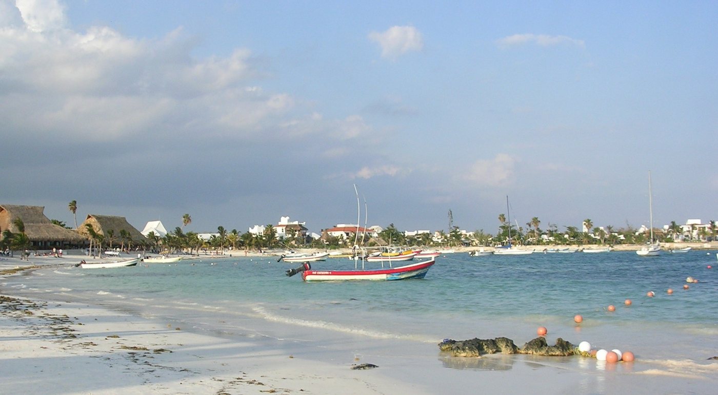 White-sand beach and fishing boats in Akumal Bay