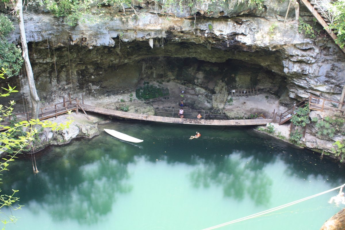 Cenote Xcanché with its wooden walkway and jade-green water