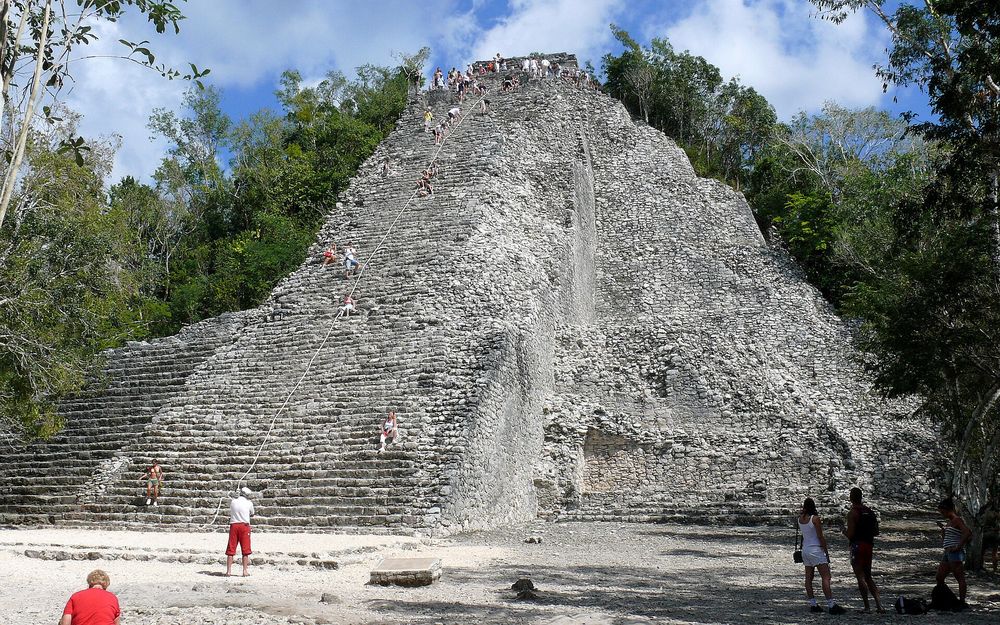 Visitors at the foot of the Nohoch Mul pyramid in Cobá