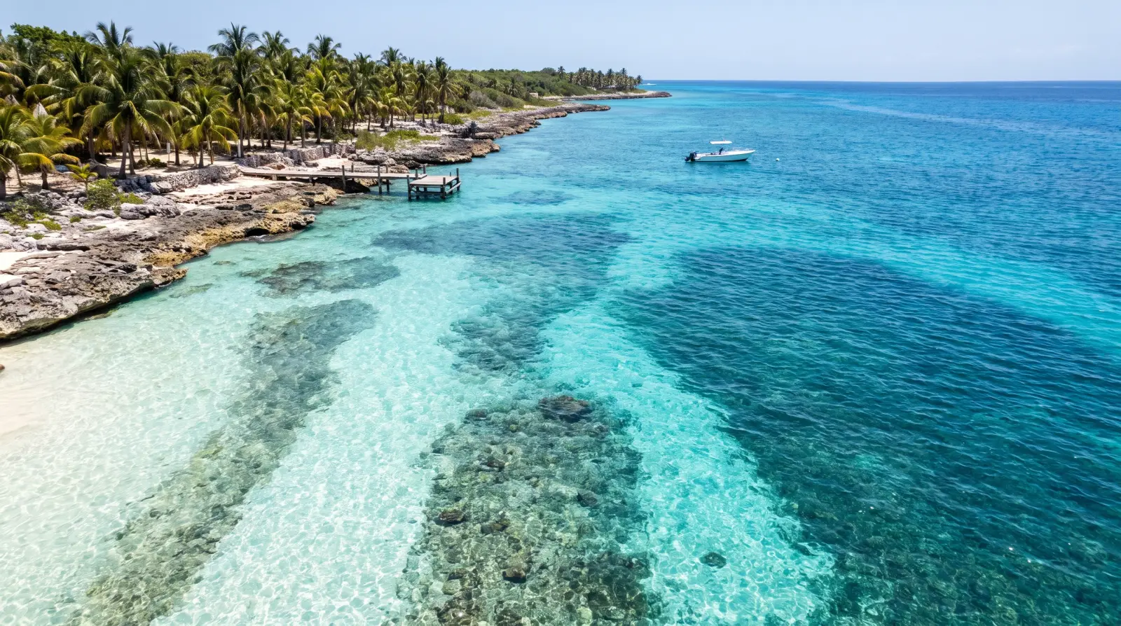 The clear reef water off the coast of Cozumel, with a dive boat moored over the shallows