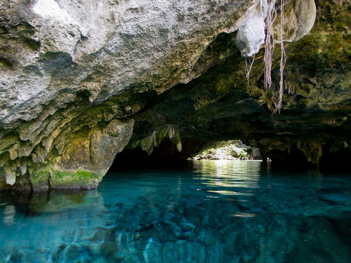 Turquoise water flowing into the cave passage at Gran Cenote
